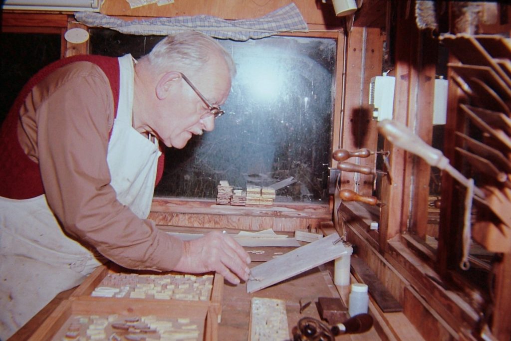Andrew Oliver laying out marquetry components c1965