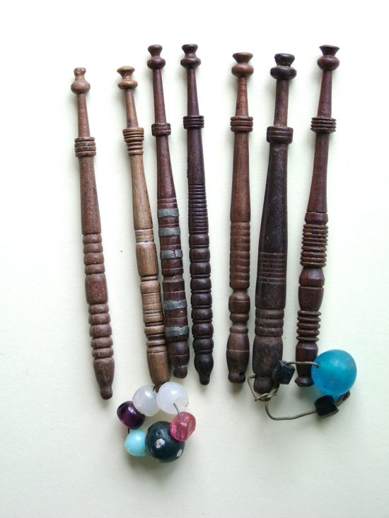 Seven Lace bobbins all turned by the same maker. South Midland style slim wooden bobbins. Although the shanks vary somewhat in design you will note a close similarity in the neck section.